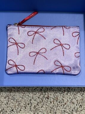 IPSY glam bag — red bows and purple background